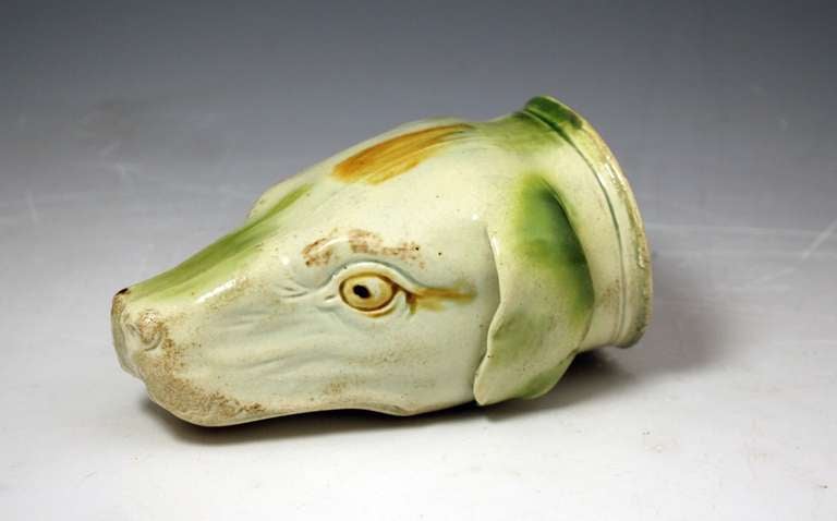 Antique English Staffordshire pottery figure of a hound head in the form of a stirrup cup. 
This early example is decorated in coloured glazes on the manner of Ralph Wood of Burslem, Staffordshire. 

Provenance:  Private USA Collection.  