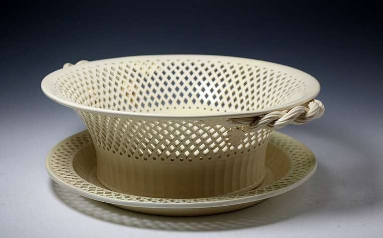 A large antique English creamware pottery basket and stand with reticulated decoration. 
The scale renders this piece one of the largest ( if not the largest) basket and stand produced in creamware in the 18th century. 

Provenance: Jonathan