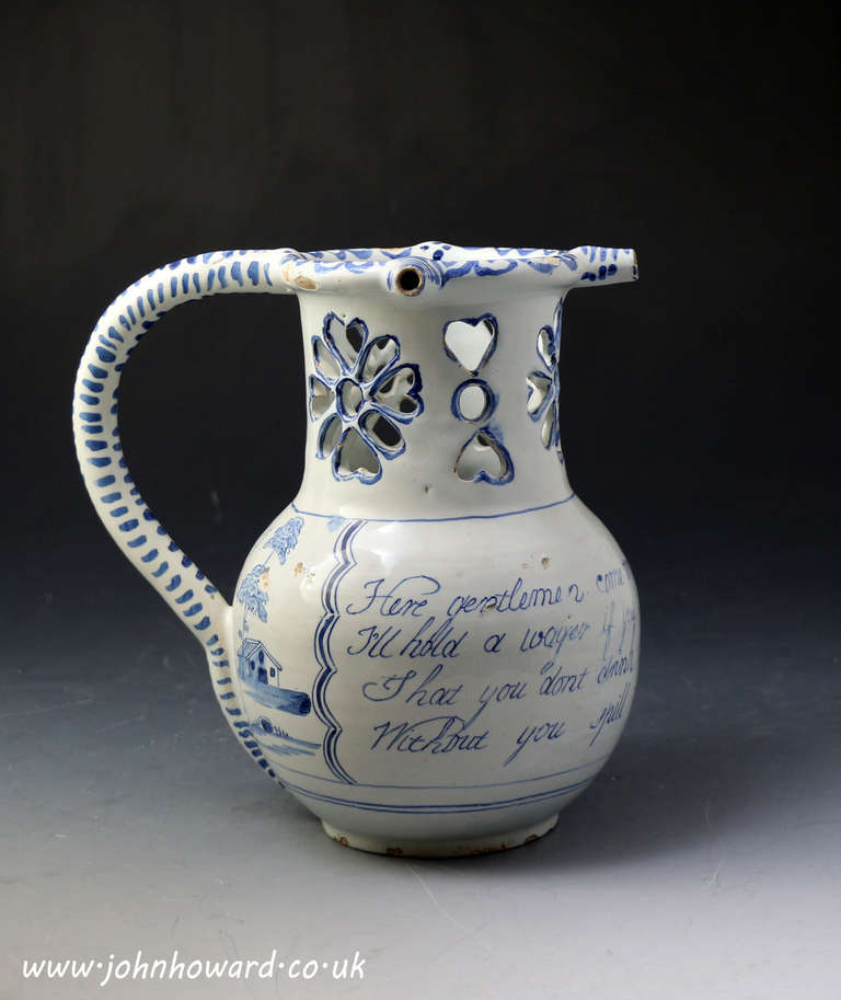 A good antique mid 18th century Liverpool pottery delftware puzzle jug in blue and white.
The handle is hollow with a hole on the underside which connects with the inside of the jug. There are three nozzles which are connected to an inner tube