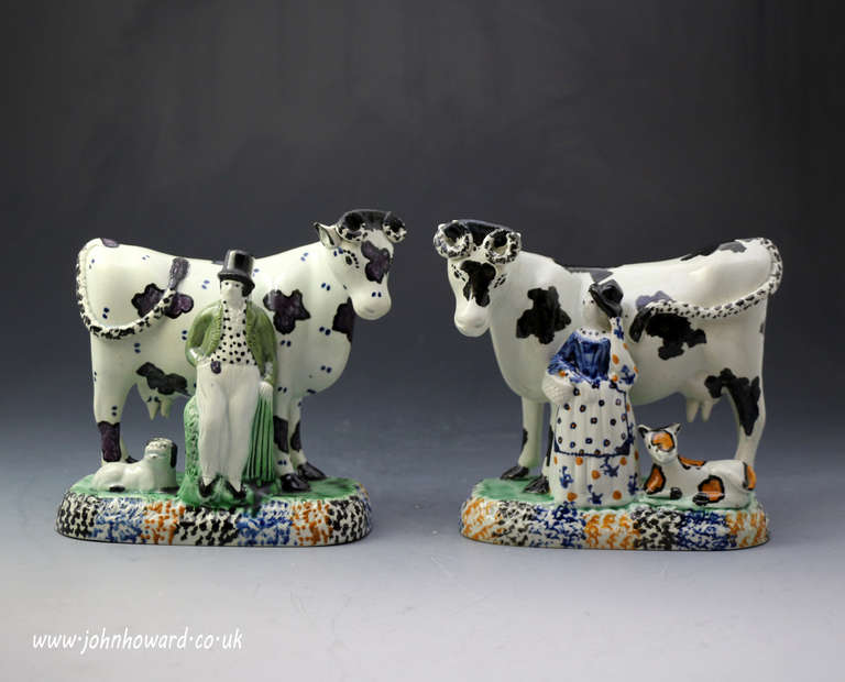An assembled pair of antique pearlware Yorkshire pottery cows with male and female attendants.
These now classic and iconic figures from the Yorkshire area in England are well colored in the Prattware palette.
They have charming folk appeal with
