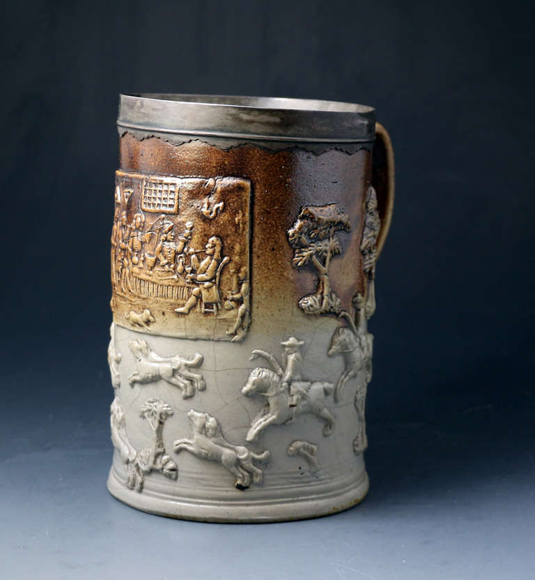 A fine Mortlake London tankard with an original white metal band at the rim.
The tankard has a central panel of the 