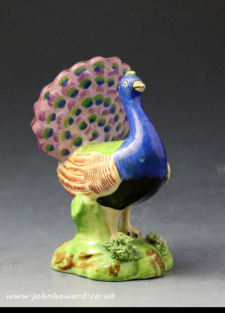 A good and clean example of a Staffordshire pottery figure of a pearlware figure of a peacock in full display. The figure is execeptionnaly well decorated in bright striking enamel colours.
The figure dates to the early 19th century period.