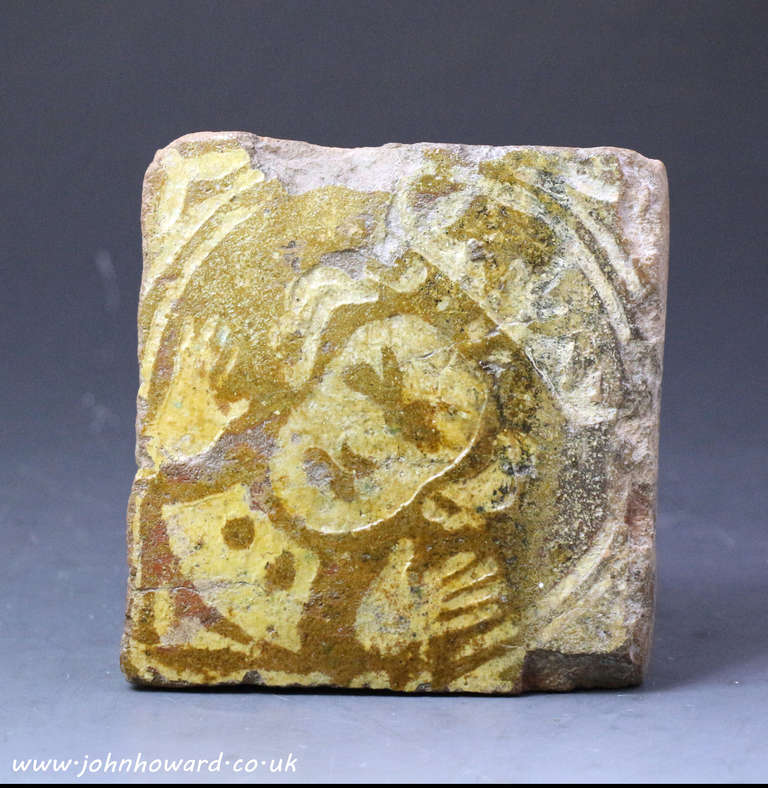 A medieval period English pottery tile with a portrait of a king.