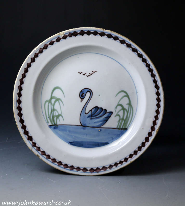 Antique decorative and rare English pottery delftware plate with a well painted image of a swan. <br />
<br />
Mid-18th century.