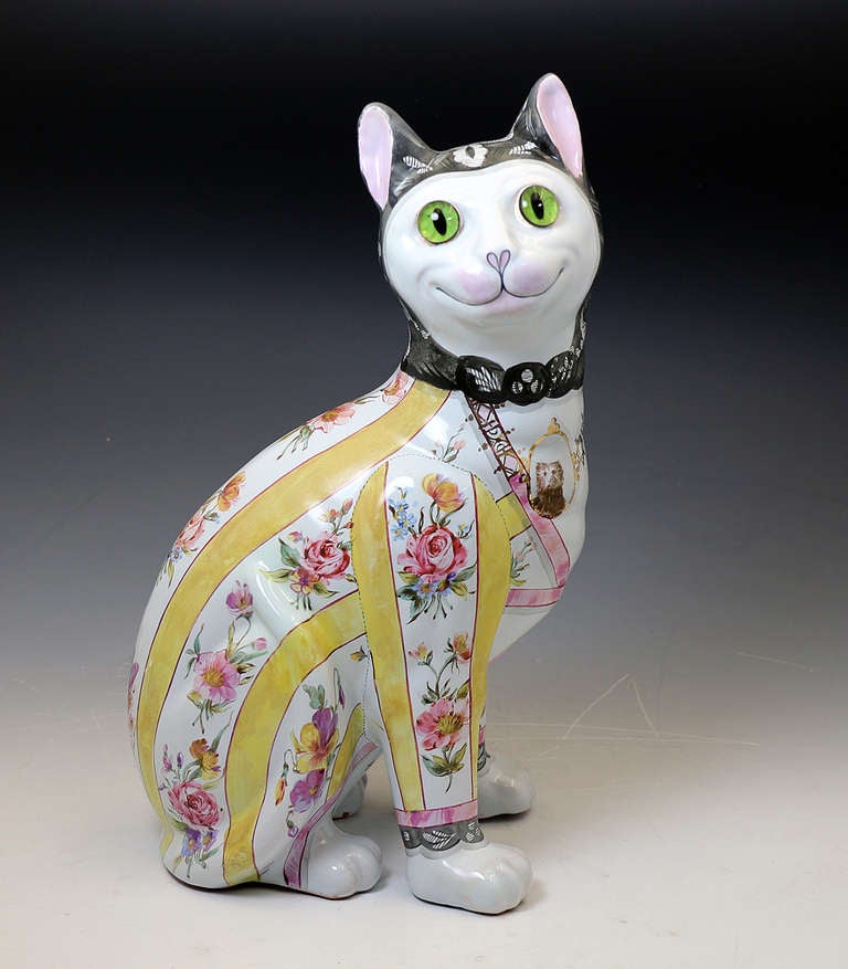 Antique pottery figure of a seated green eyed cat wearing a striped and floral outfit ( the glass eyes are very realistic). This figure is an original piece from Emile Galle of Nancy, his work is often copied but never surpassed. The figure captures