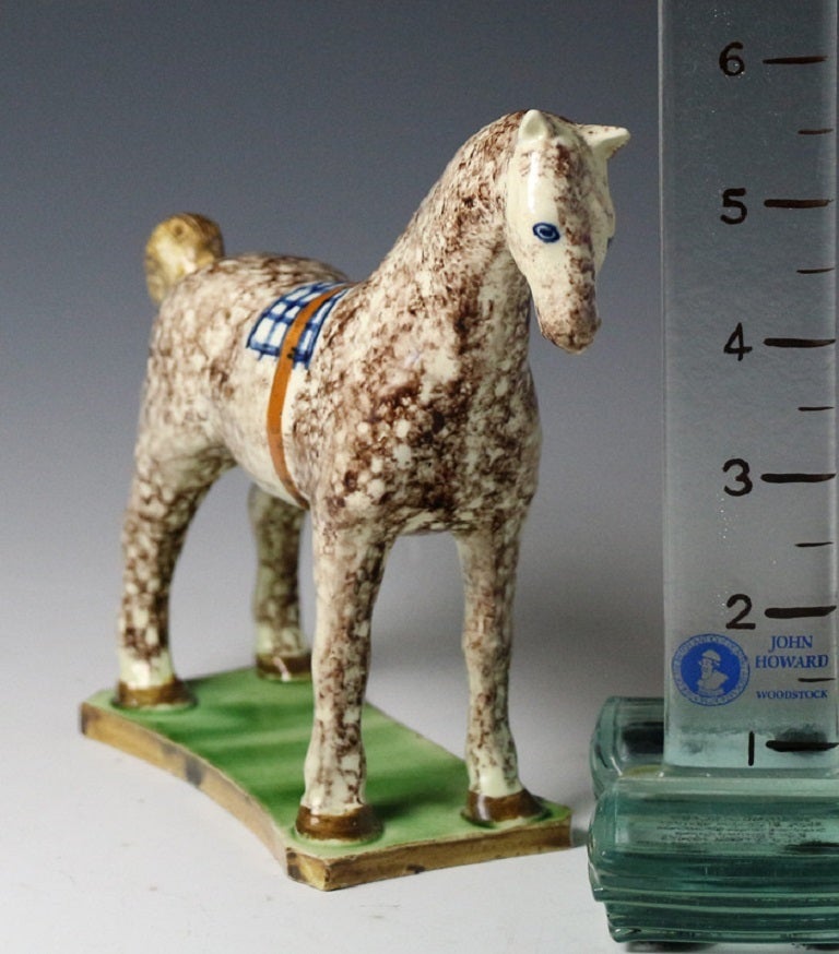 A fine and rare example of a sponge decorated horse standing on a base . The figure is well modeled and has a strong decorative folk appeal.