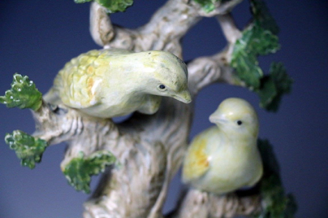 Staffordshire pottery pearlware figure group of two yellow birds perched in branches and modeled on a square faux marble decorated base. 
The figure has a charming tender quality.