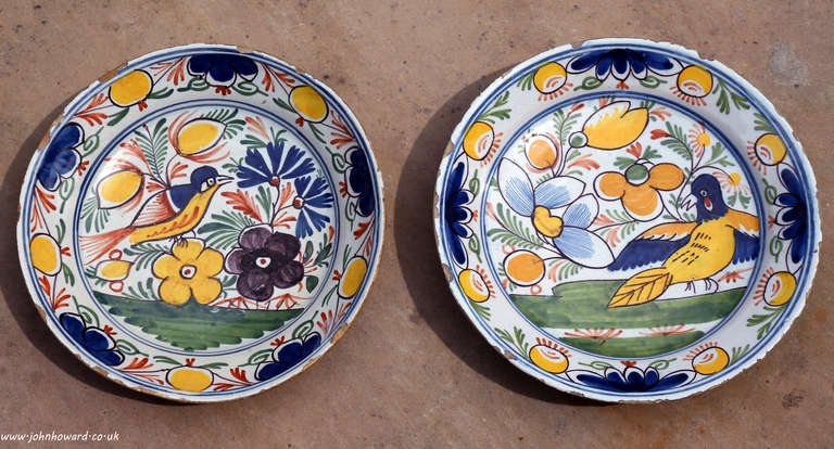 A very decorative pair of late 18th century Dutch Delft dishes with images of birds in foliage.