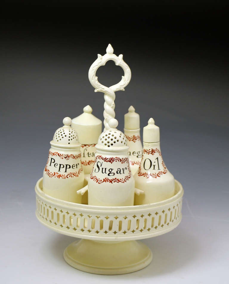 A fine antique period creamware pottery cruet set, 18th century, dating circa 1780.
The stand is in fine condition as well as the various bottles and shakers in the set.
The lids have been replaced on three of the pieces.
The set is very striking