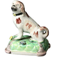Staffordshire Pearlware Pottery Figure of a Seated Dog on a Tassled Cushion Base