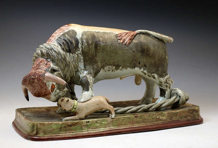 Antique Staffordshire pottery pearlware Bull Baiting figure group. 
The bull is very well modelled especially the beasts head. 
An unusual feature is the bulls foot place stamping on the pit bull terrier. 
All the features on this figure are very