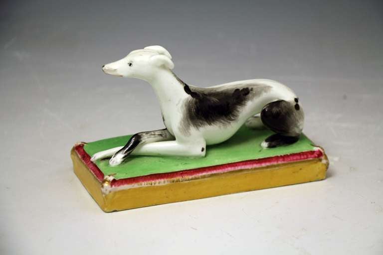 Antique figure of a whippet or Italian Greyhound dog modelled on base. 
Early Victorian period circa 1840. 
This figure is finely modelled with good quality decoration. 

Provenance:  Private English Collection