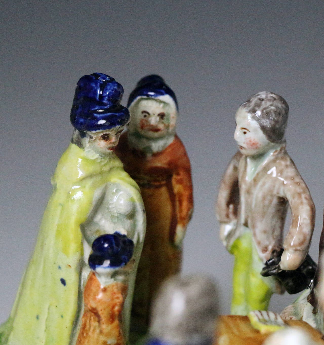 Pearlware Staffordshire pottery figure group of a Baptism with enamel colours. 
The group of figures are modelled standing in front of a clock tower which has a steps leading to a table with ritual objects associated with Christenings. 
The group