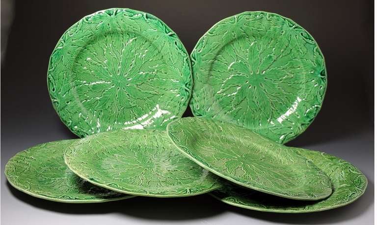 Set of six antique green glaze pottery plates from the famous Herculaneum Pottery in Liverpool. The plates have a wonderful green glaze over a well defined relief molded pattern of leaves. 
There is a slight variation in the green glazes which adds