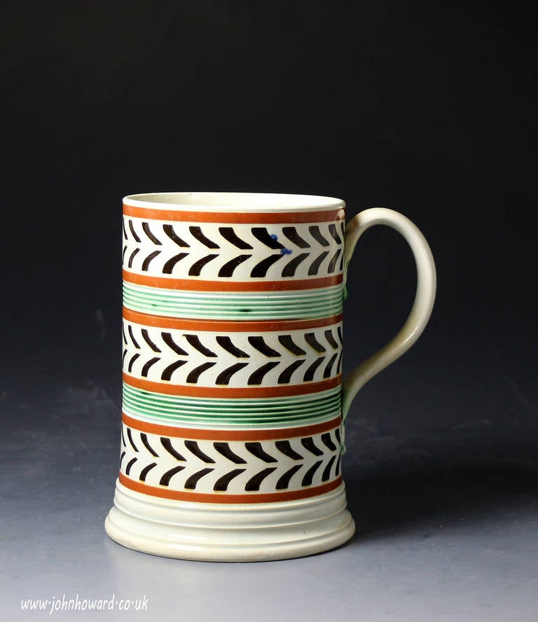A fine antique pottery mocha tankard with engine turned bands in the centre of the body. 
This unusual feature ( the bands are usually present on the rims) gives extra appeal to the simple but sublime decoration. 
The tankard is very finely potted