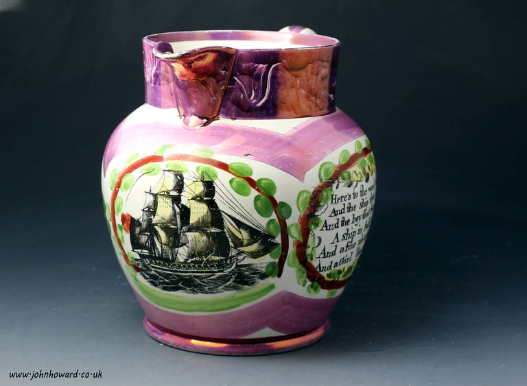 Antique English pottery pink splash luster pitcher. The jug is decorated with underglaze transfer prints one of a sailing ship and the other with a poem. This type of ware is usually associated wth the SUnderland Pottery although this piece would