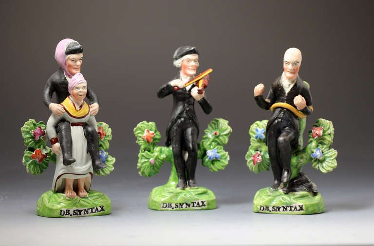 A rare trio of Staffordshire pottery figures representing the exploits of Doctor Syntax, Syntax arriving at Calais, playing the violin and tied to a tree after been robbed by highway man.
The figures are amusingly modelled and have a very