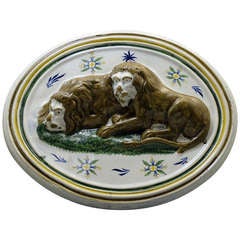 Prattware pottery relief moulded plaque with figures of two resting lions.c1800