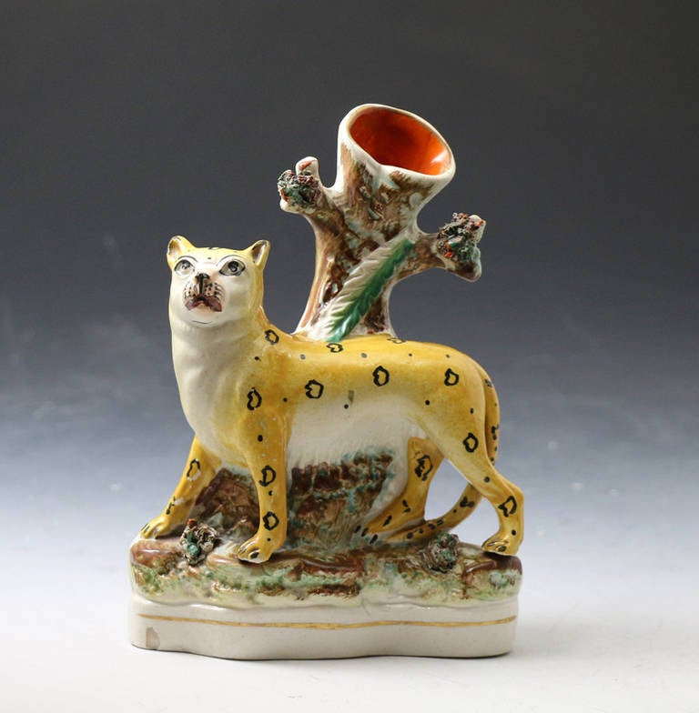 A good antique Staffordshire pottery figure of a leopard in the form of a spill vase. 
The figure is very well potted and modelled.