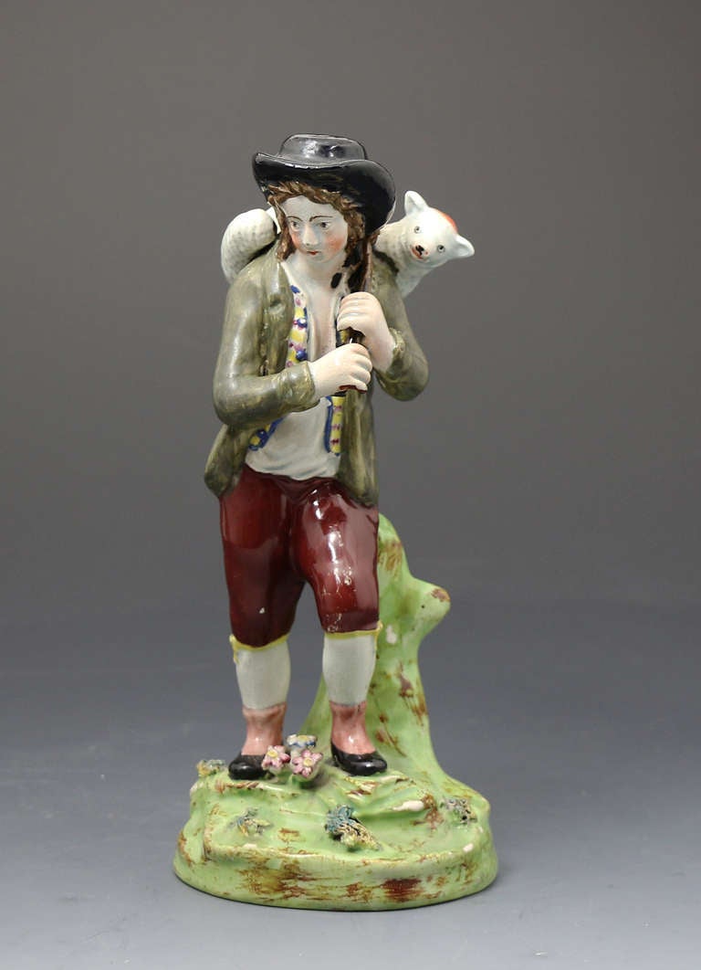 A good decorative appealing figure of shepherd returning home after locating a lost sheep from his flock. 
This figure was very popular in the early 19th century as it reflects a spiritual ethos of the time with a warm story to tell as it