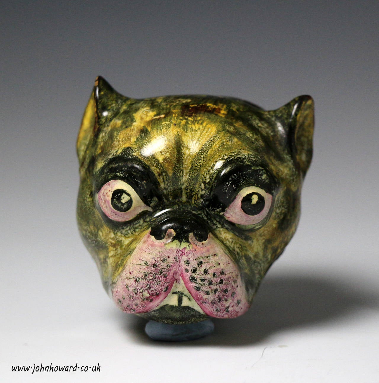A very rare English pottery snuff box in the form a pug dogs head. 
The pottery figure is decorated in underglaze Pratt type colours, the hinged original cover is pewter. Interestingly the name 