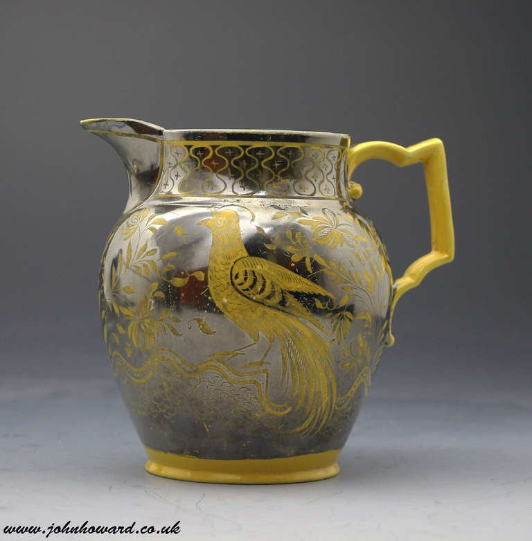 Antique pottery pitcher with a canary yellow ground and silver resist luster with images of a bird perched in foliage. 
Attribution English or Welsh. 

Provenance: Private English Collection