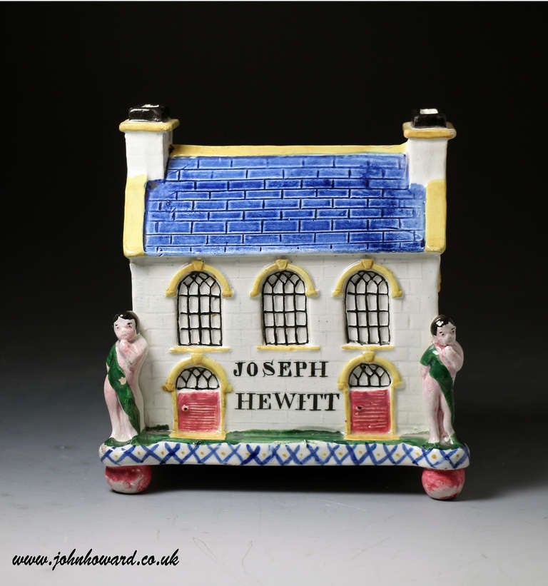 Antique period pottery Wesleyian Chapel money box bank Mexborough pottery Yorkshire. 
The Chapel ( still standing in Mexborough) is flanked by two cherubs and has the name JOSEPH HEWITT in capitals across the front wall. 
These charming banks were