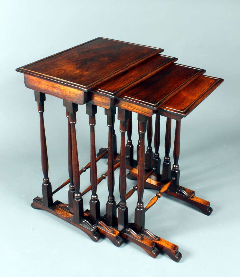 A set of Regency rosewood quartetto tables of a good original colour and patina. The smallest table has a well repaired crack, otherwise they are in good order