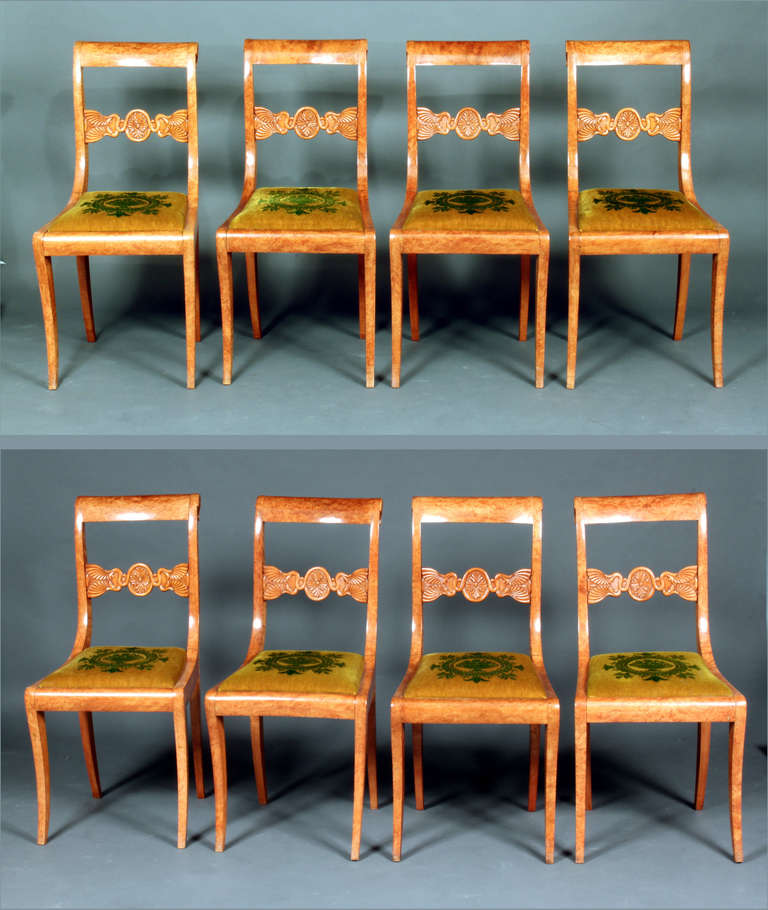 An early 19th century set of 8 biedermeier sabre leg chairs in superb figured timber, upholstered in embossed Genoa velvet