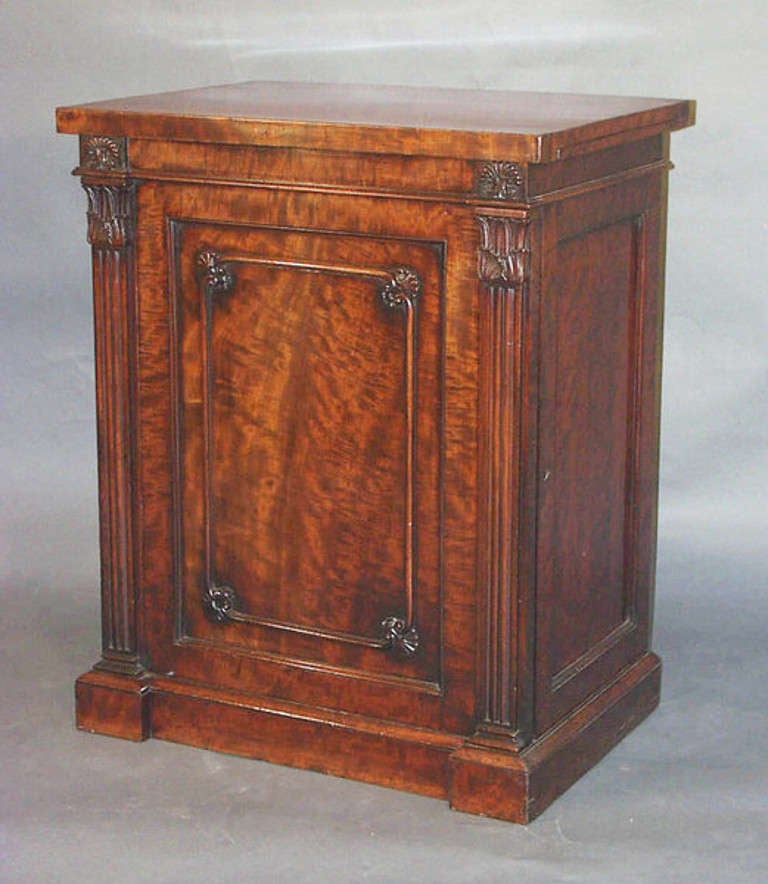 A fine Regency library or dining room cabinet in well figured mahogany with front opening door and slides at each side beneath the top; not stamped but almost certainly by Gillows of Lancaster. 