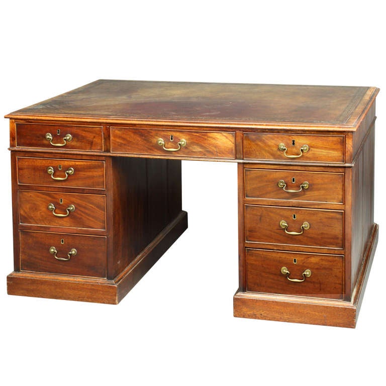 A George III Chippendale period pedestal desk of a good colour and patina, still with its original set of swan neck handles: good model with false drawers on the back.
