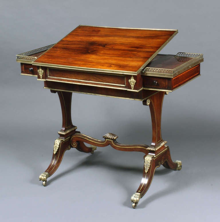 A fine Regency rosewood games table with brass mounts; right drawer fitted for ink bottles, integral chess and backgammon boards: I was told it was by George Oakley though I need to research this attribution further.