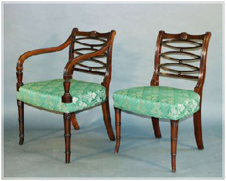 Good set of eight large and comfortable George III mahogany dining chairs: model illustrated in the Sheraton Pattern Book: includes two arm chairs which are significanty larger than the side chairs (one arm chair is a later copy)