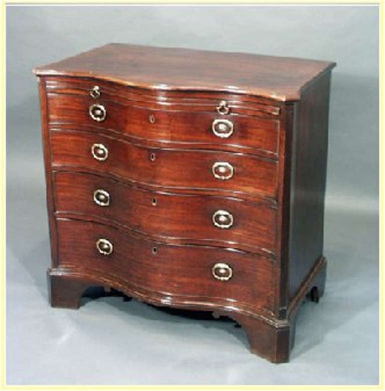 A rare George III mahogany serpentine chest, only 35.5" wide with reeded canted corners, shaped sides and good rich color.