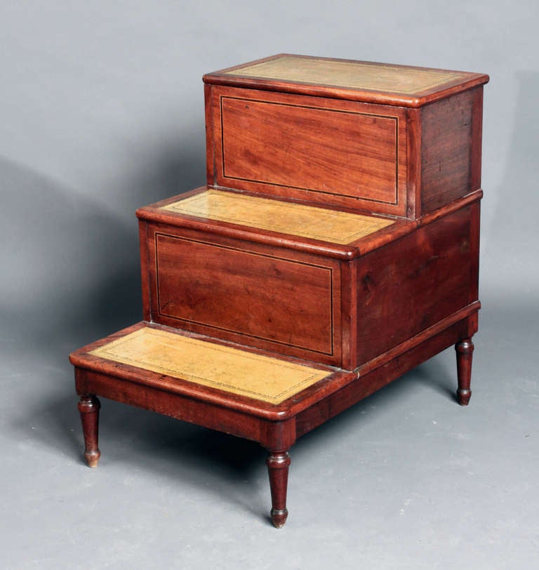 A set of Georgian mahogany bed steps with box wood and ebony stringing: the treads with good quality pale green hide. The commode removed and now a hinged compartment