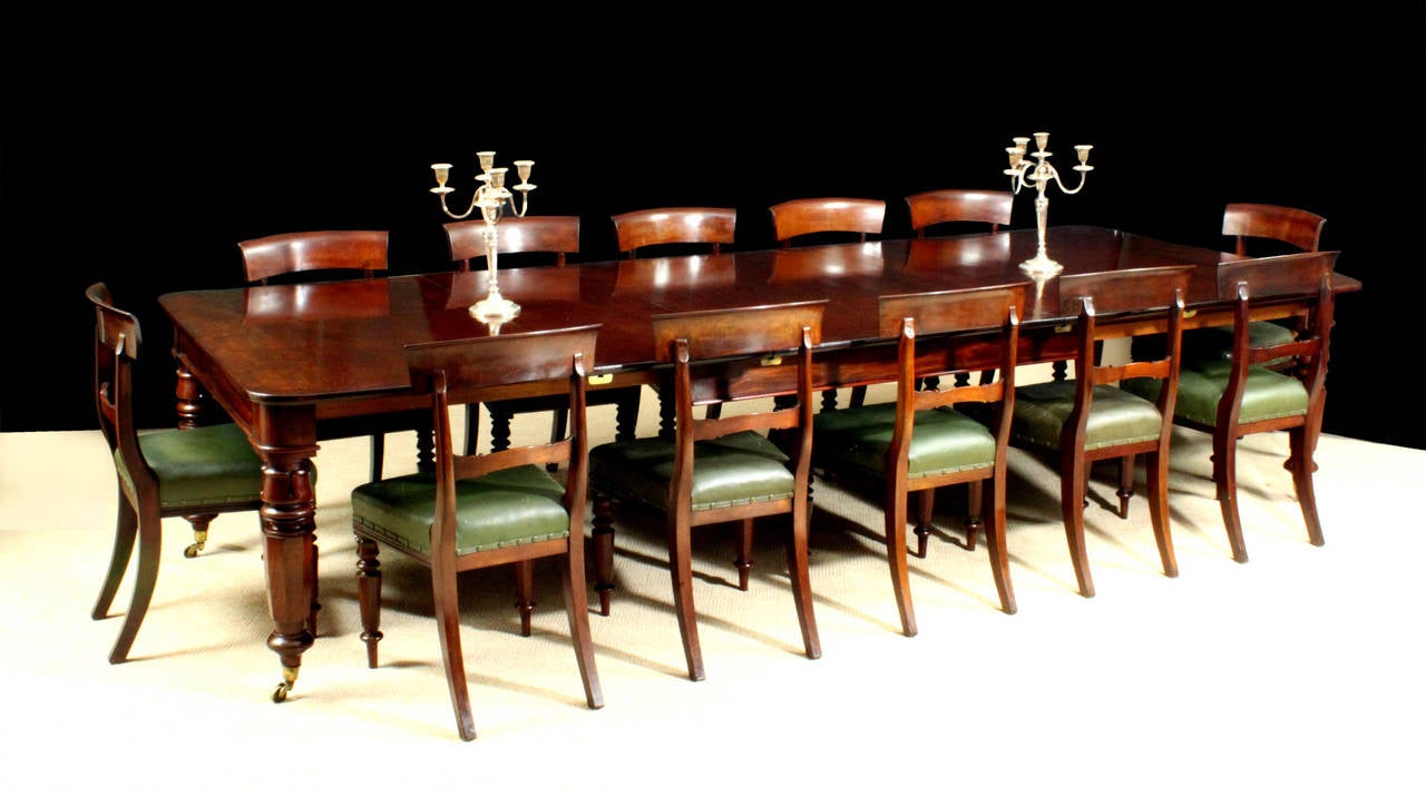 English Antique dining table with matching set of twelve dining chairs