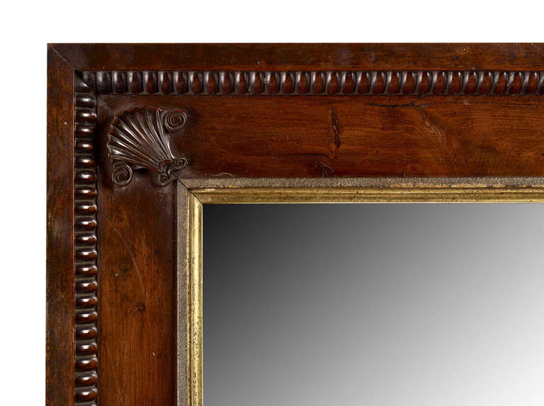 A rare Irish William IV yew frame carved with scallop shells in each corner, associated old mirror plate.