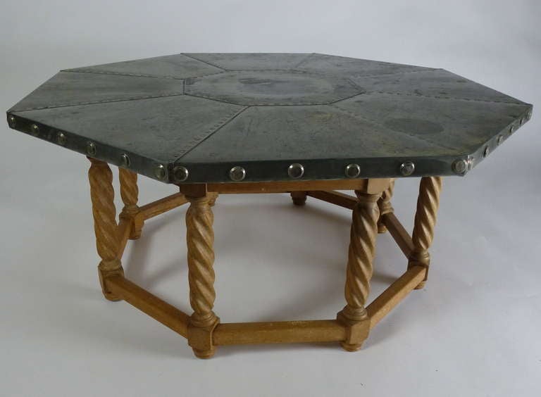 An oak and aluminium centre table, the octagonal top with copper rivets on oak barley twist supports.