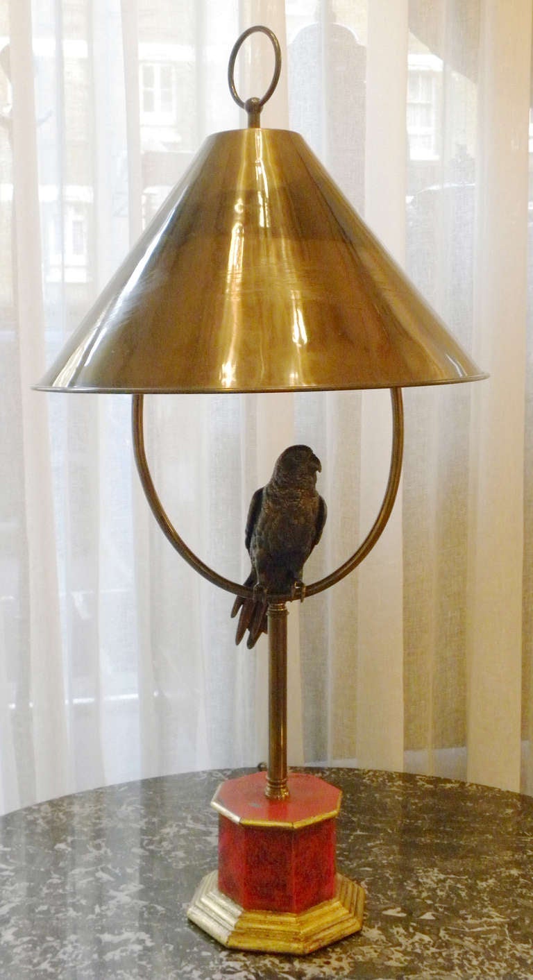 1930s French brass parrot table lamp with brass empire shade and wooden
octagonal base.