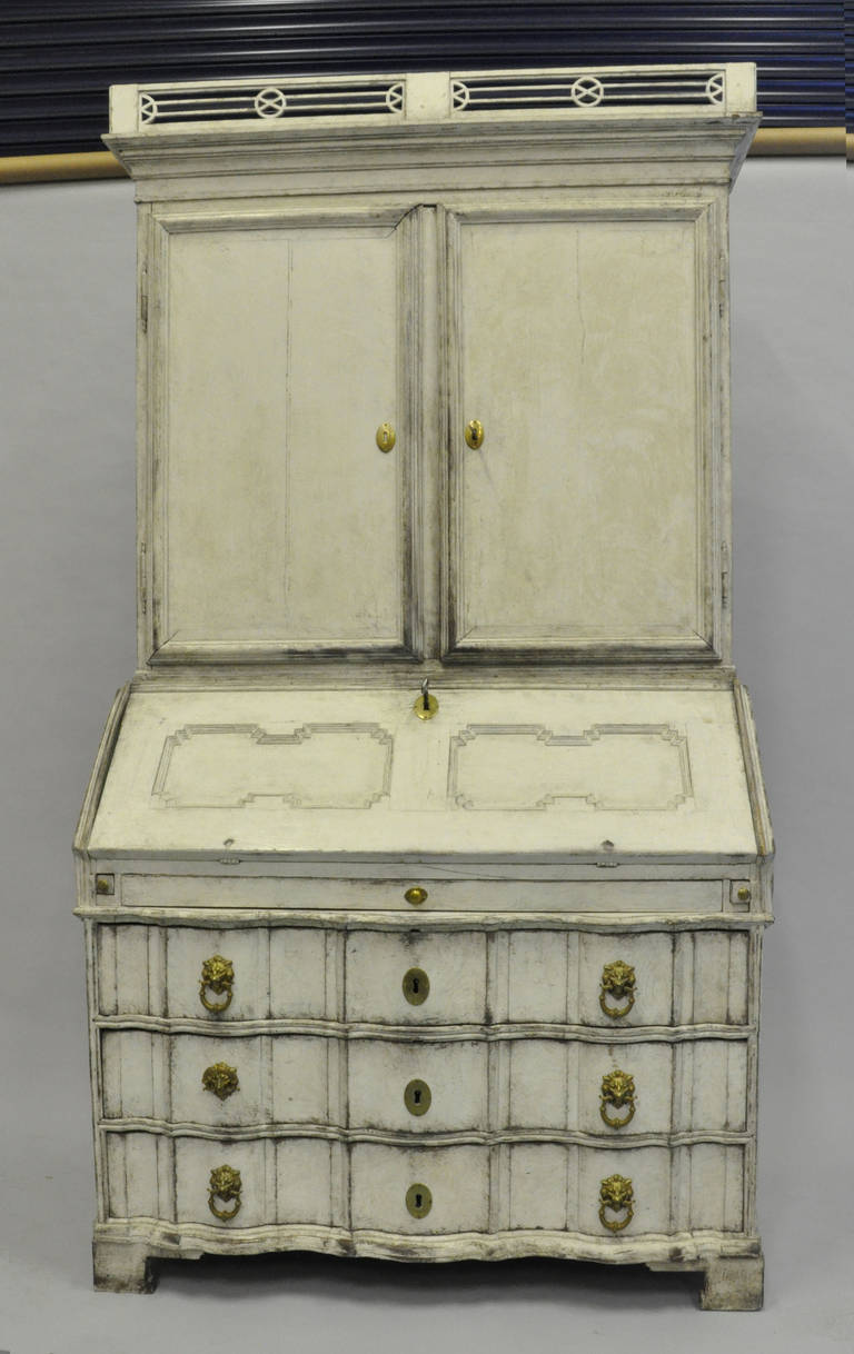 A rare 18th Century Secretaire with brass lion head handles.