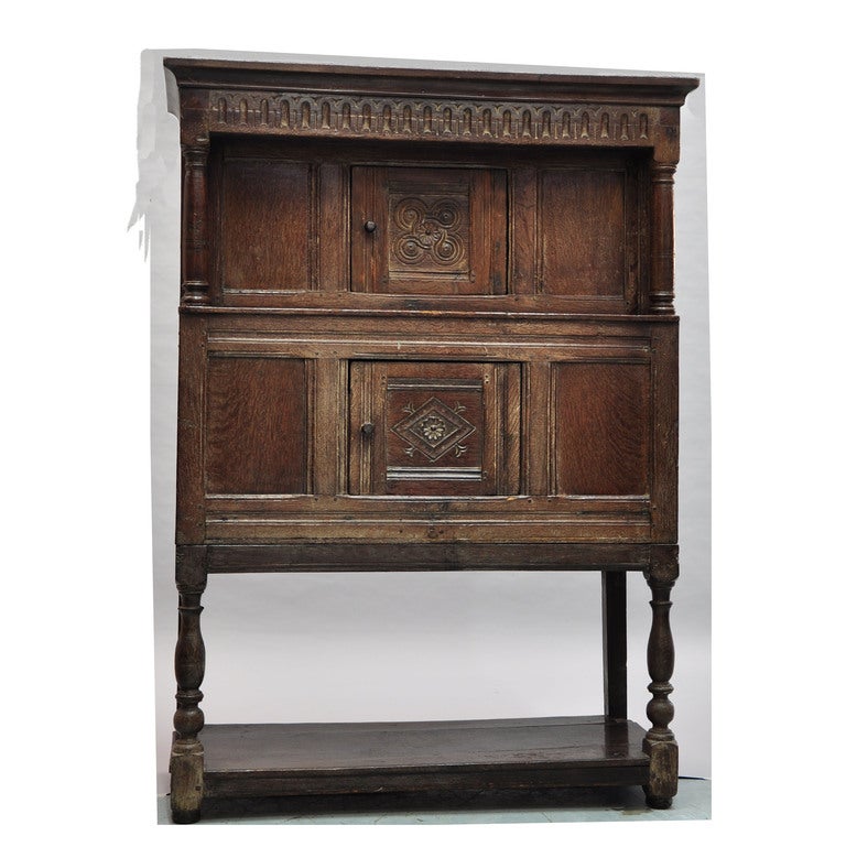 Beautifully carved Oak Tudor cabinet with two cupboards and lower shelf.