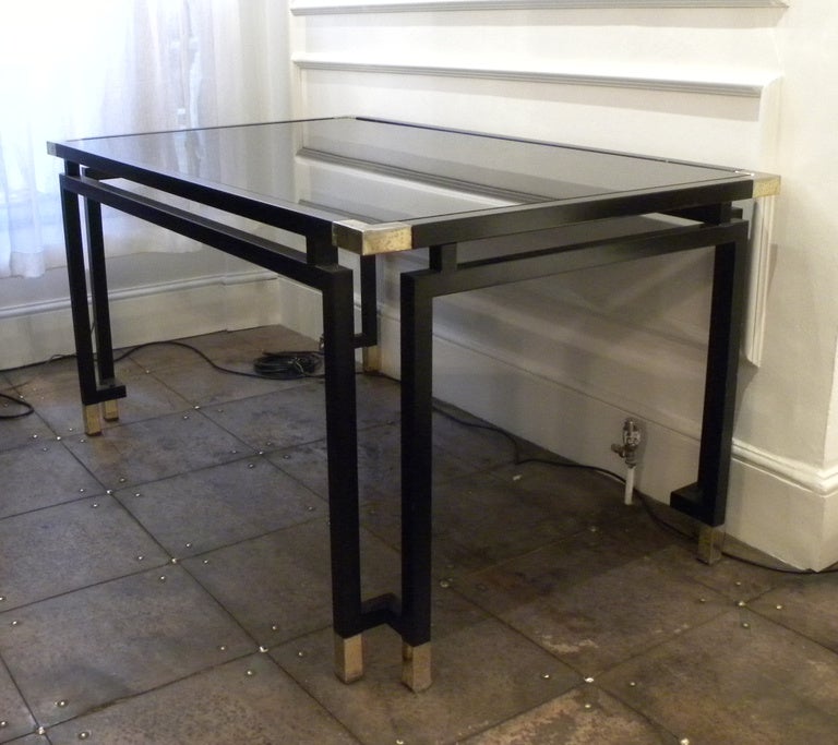 1970's Italian metal and glass dining table. Painted metal base and frame with brass feet and corner details. recently refurbished and black glass top replaced.
