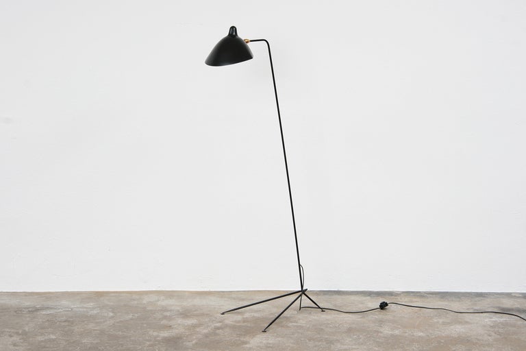 Reedition of a design classic by Serge Mouille with tapered tripod base and swiveling shade, in black.