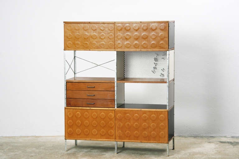 Extraordinary shelf with veneer sliding doors, zinced metal frame and lacquered wood covers. Designed by Charles & Ray Eames, produced by Herman Miller.