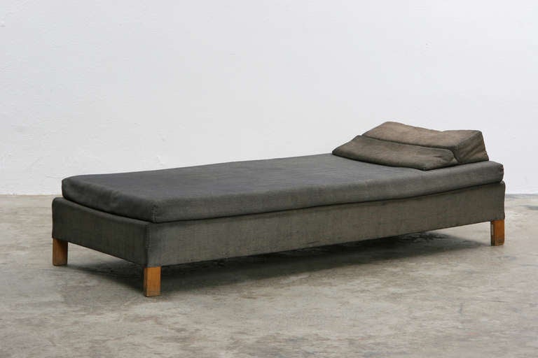 Unique daybed with wedge shaped headrest which can be folded into an armrest. Designed in 1953 by German Ferdinand Kramer for Goethe University Frankfurt.

Ferdinand Kramer was a German modernist who was chosen to develop new buildings and interior