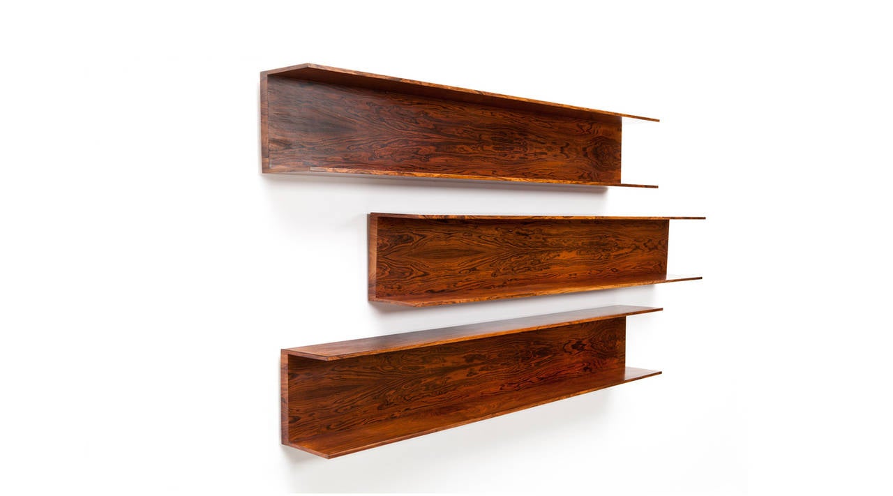 Set of three hanging wall Shelfs designed by german Designer Walter Wirtz. The shelves in its simple character are made out of rosewood. Manufactured by Wilhelm Renz