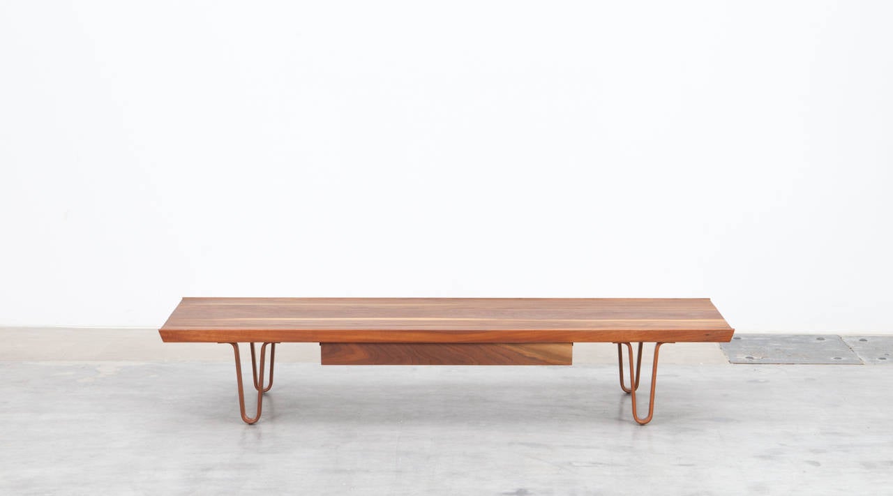 Edward Wormley bench made out of solid walnut wood with single drawer can also be used as a coffee table. The remarkable feet are plywood. Manufactured by Dunbar.