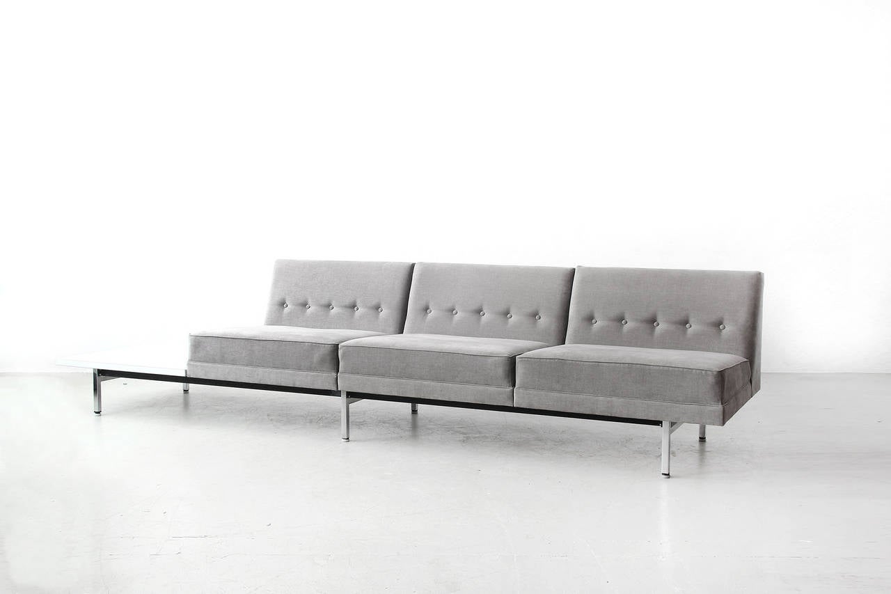 Very beautiful Three Seater Sofa with table by George Nelson for Herman Miller in 1963. Very good condition, newly reupholstered with high quality fabric in grey.

We have a matching Two Seater Sofa with table in stock.