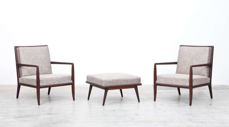 Pair of lounge chairs and ottoman designed by T.H. Robsjohn-Gibbings. Solid walnut with new upholstery in high-quality fabric. Manufactured by Widdicomb.