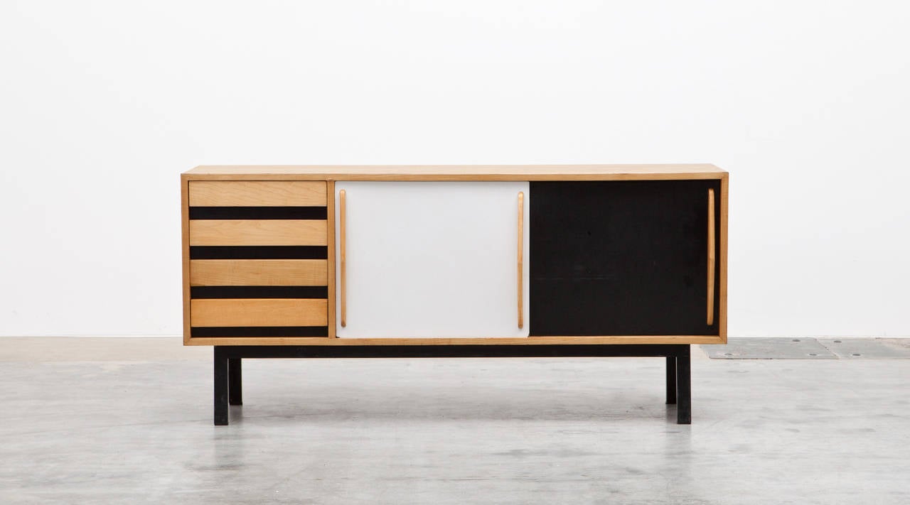 Beautiful and really rare Charlotte Perriand sideboard edited by Steph Simon. The corpus, drawers and grips are in ash veneer, the sliding doors are laminate. The sideboard is from Casando, Mauritania in Africa.